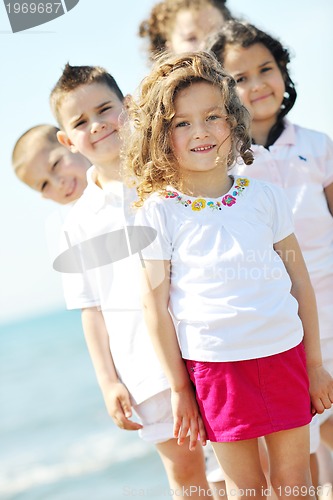 Image of happy child group playing  on beach