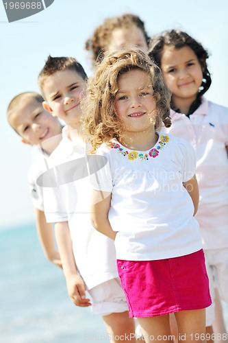 Image of happy child group playing  on beach