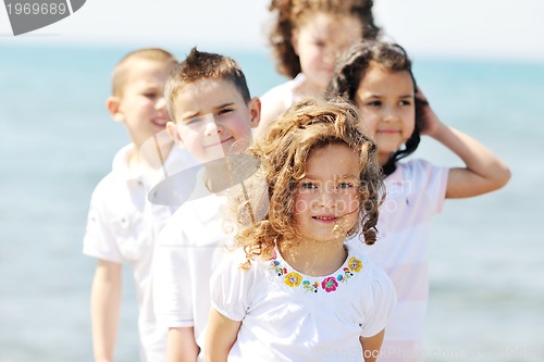 Image of happy child group playing  on beach