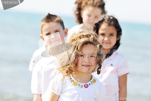 Image of happy child group playing  on beach