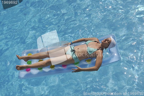 Image of woman relax at swimming pool 