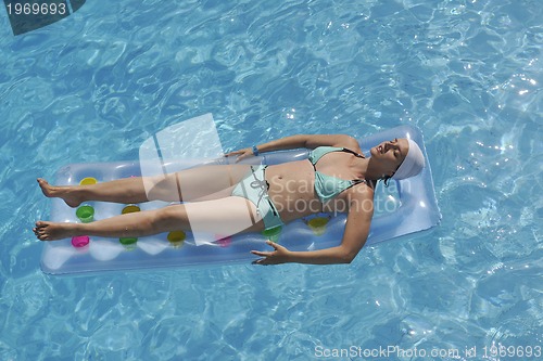 Image of woman relax at swimming pool 