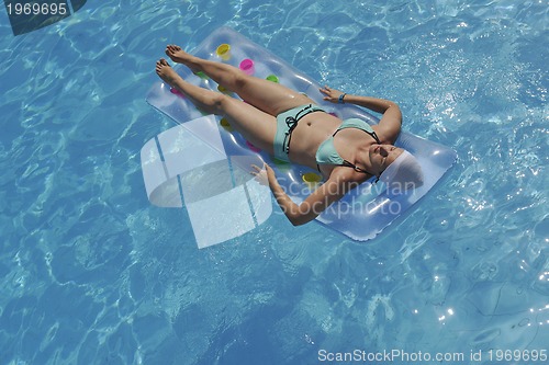 Image of woman relax at swimming pool 