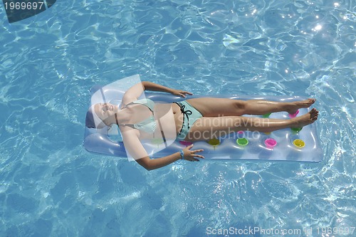 Image of woman relax at swimming pool 