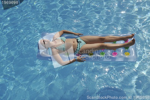 Image of woman relax at swimming pool 