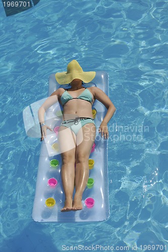 Image of woman relax at swimming pool 