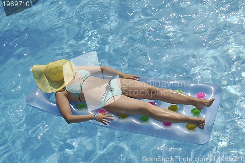 Image of woman relax at swimming pool 