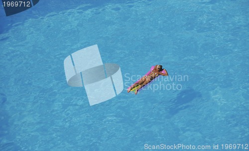 Image of woman relax at swimming pool 