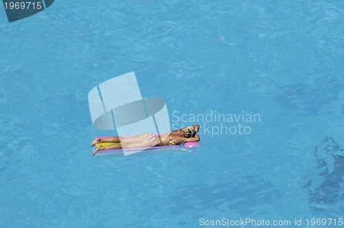 Image of woman relax at swimming pool 