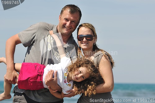 Image of happy young family have fun on beach