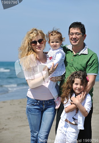 Image of happy young family have fun on beach