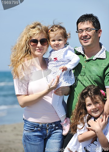 Image of happy young family have fun on beach