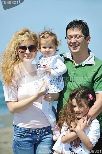 Image of happy young family have fun on beach