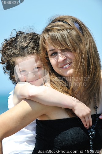 Image of group portrait of childrens with teacher on beach