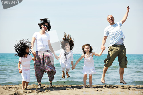Image of happy young family have fun on beach