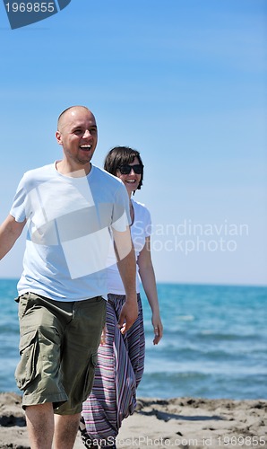 Image of happy young couple have fun on beach