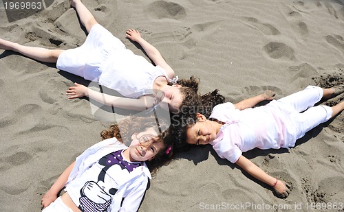 Image of happy child group playing  on beach
