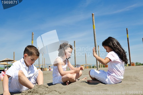 Image of happy child group playing  on beach