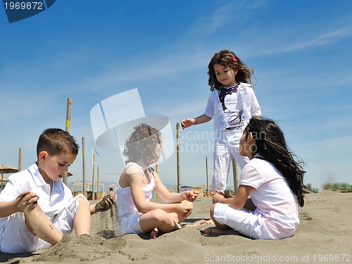 Image of happy child group playing  on beach