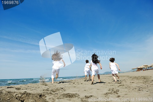 Image of happy child group playing  on beach