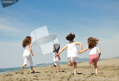 Image of happy child group playing  on beach