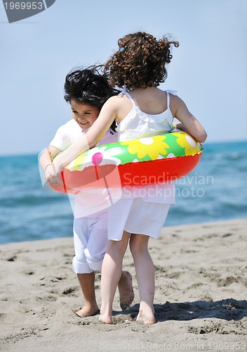 Image of happy child group playing  on beach
