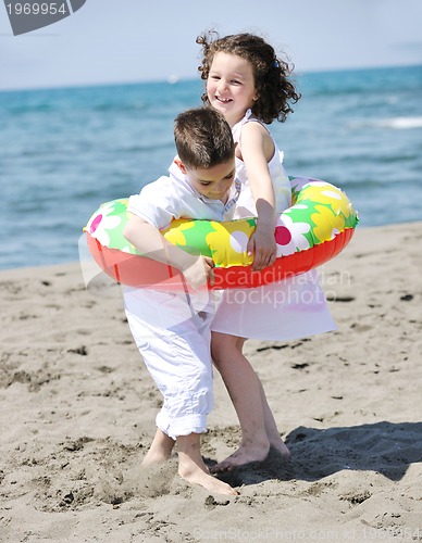 Image of happy child group playing  on beach