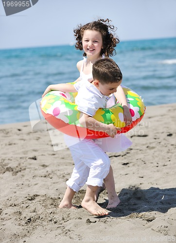 Image of happy child group playing  on beach