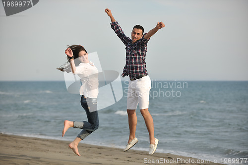 Image of happy young couple have fun on beach