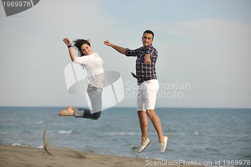 Image of happy young couple have fun on beach