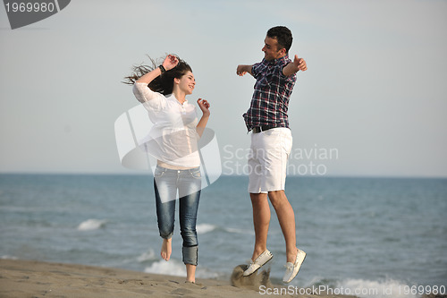 Image of happy young couple have fun on beach