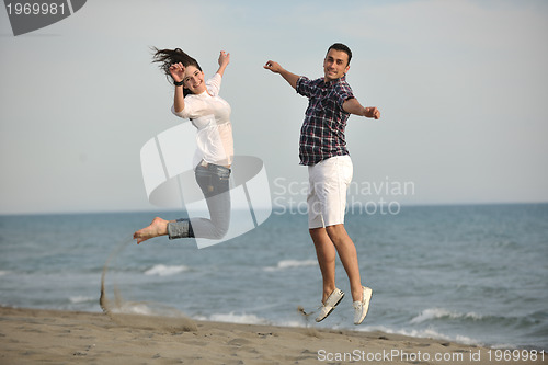 Image of happy young couple have fun on beach