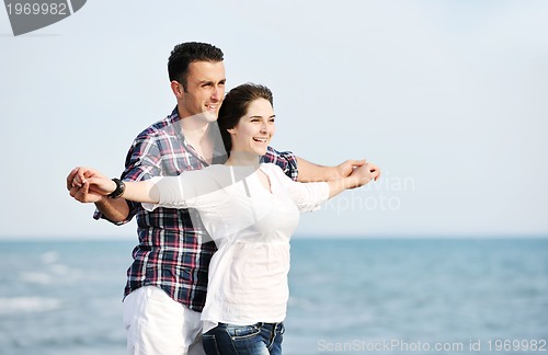 Image of happy young couple have fun on beach