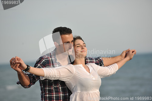 Image of happy young couple have fun on beach