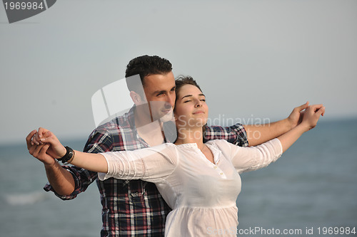 Image of happy young couple have fun on beach