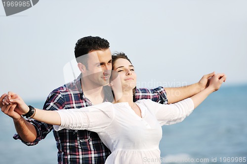 Image of happy young couple have fun on beach