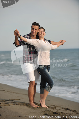 Image of happy young couple have fun on beach
