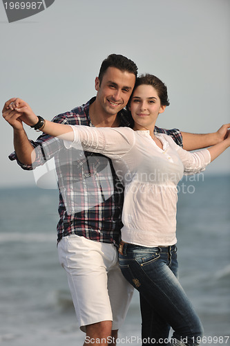 Image of happy young couple have fun on beach