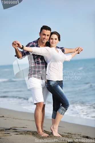 Image of happy young couple have fun on beach