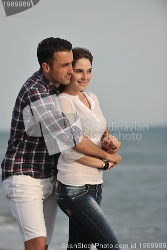 Image of happy young couple have fun on beach