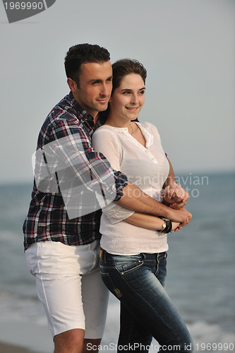 Image of happy young couple have fun on beach