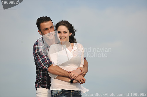 Image of happy young couple have fun on beach