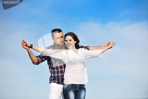 Image of happy young couple have fun on beach