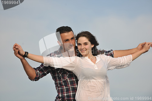 Image of happy young couple have fun on beach