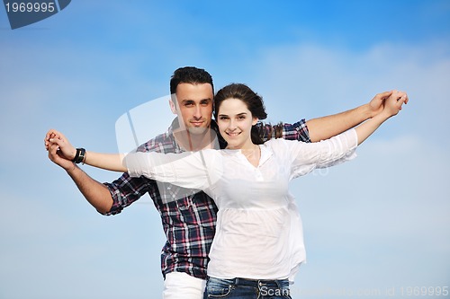 Image of happy young couple have fun on beach