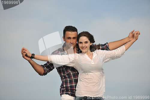 Image of happy young couple have fun on beach