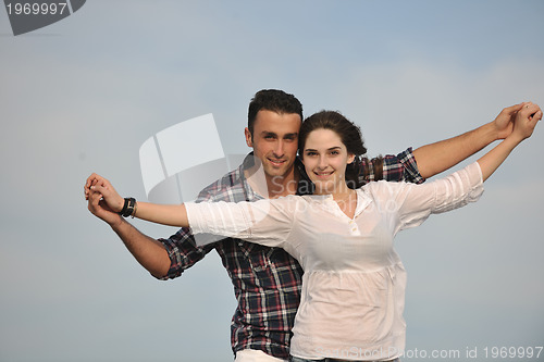 Image of happy young couple have fun on beach