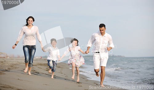 Image of happy young family have fun on beach