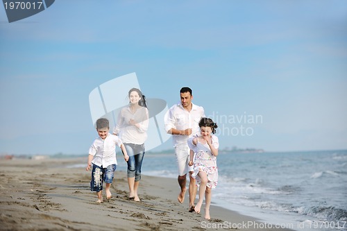 Image of happy young family have fun on beach