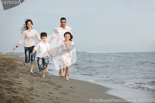 Image of happy young family have fun on beach